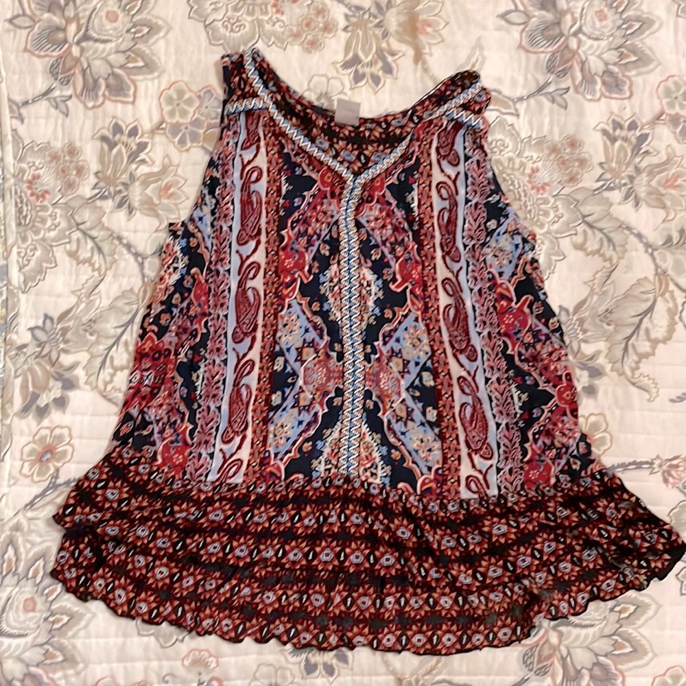 Blouse. Lots of patterns, red, blue, black.